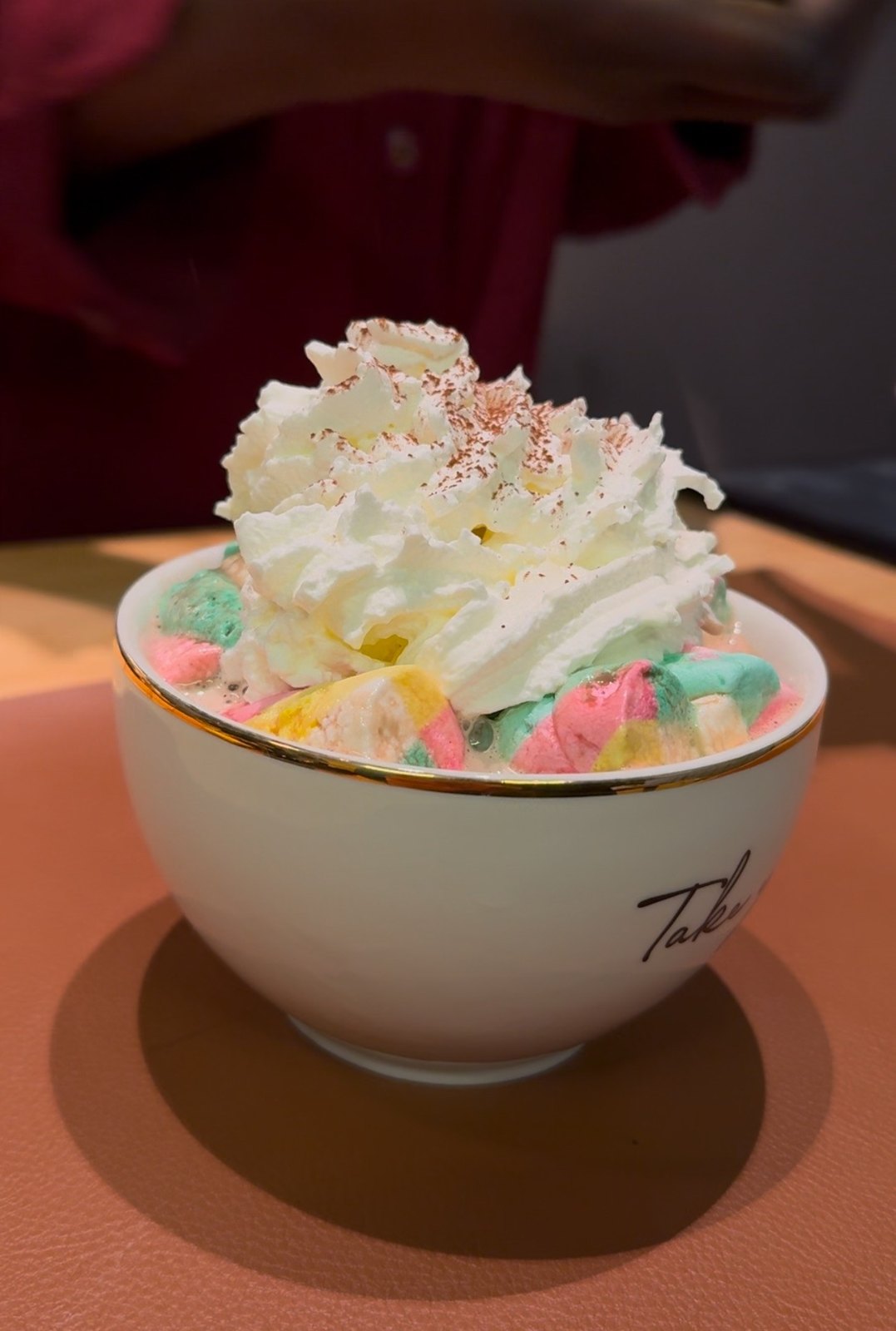 A colourful sweet treat topped with whipped cream